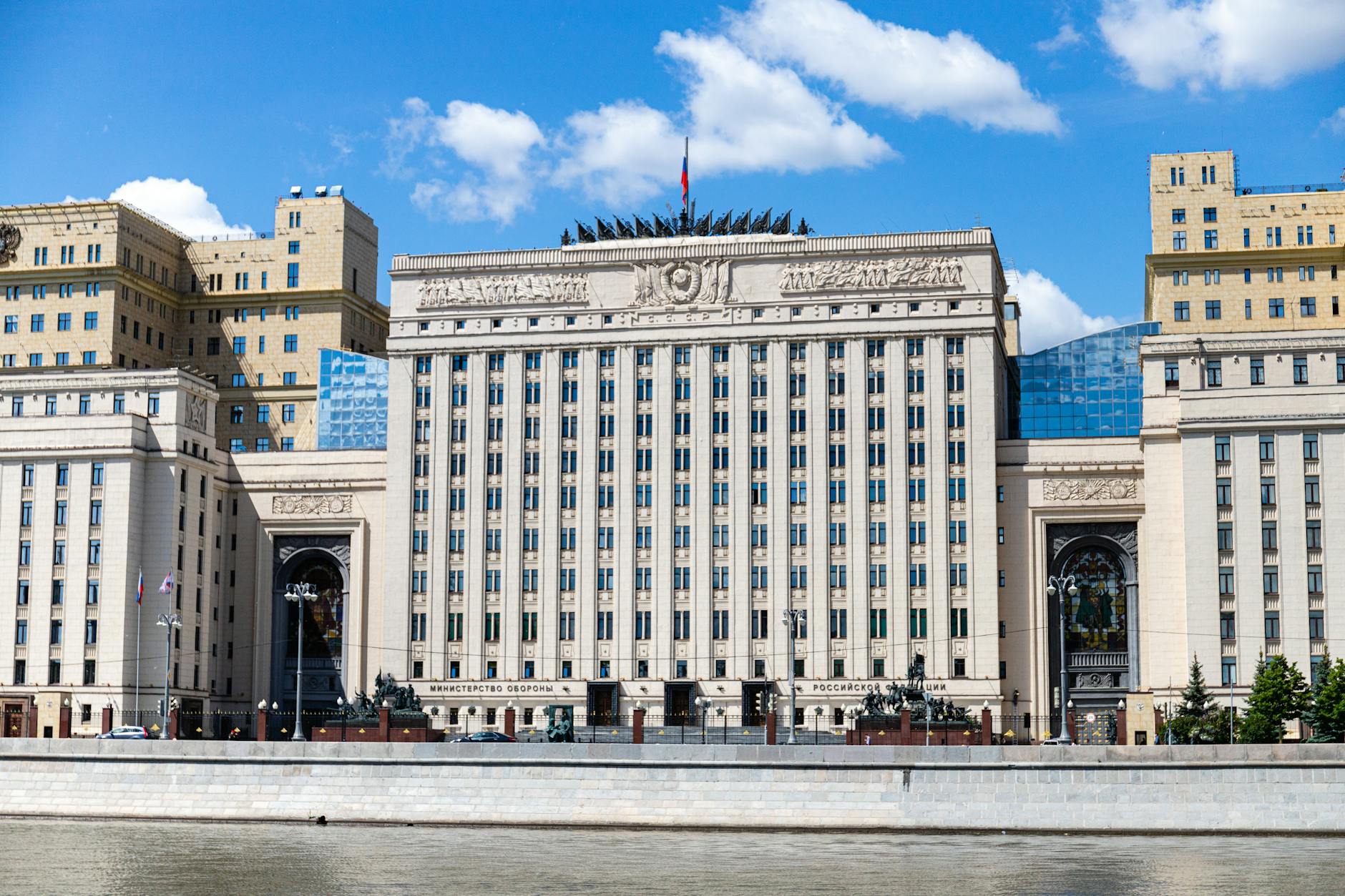 Facade of the Russian Ministry building in Moscow along the river under a clear sky.