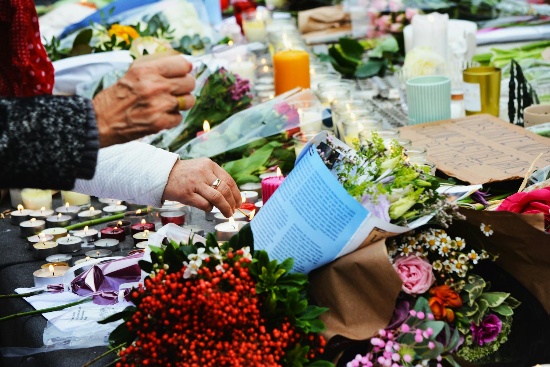 A touching scene of a memorial with flowers and candles.